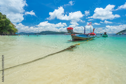 Boats off the coast of Phuket, clear water and white sand