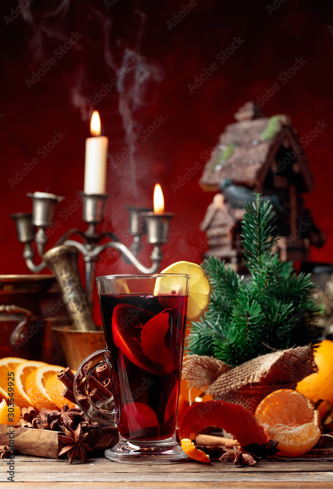 Mulled wine and Christmas decorations with candlesticks.