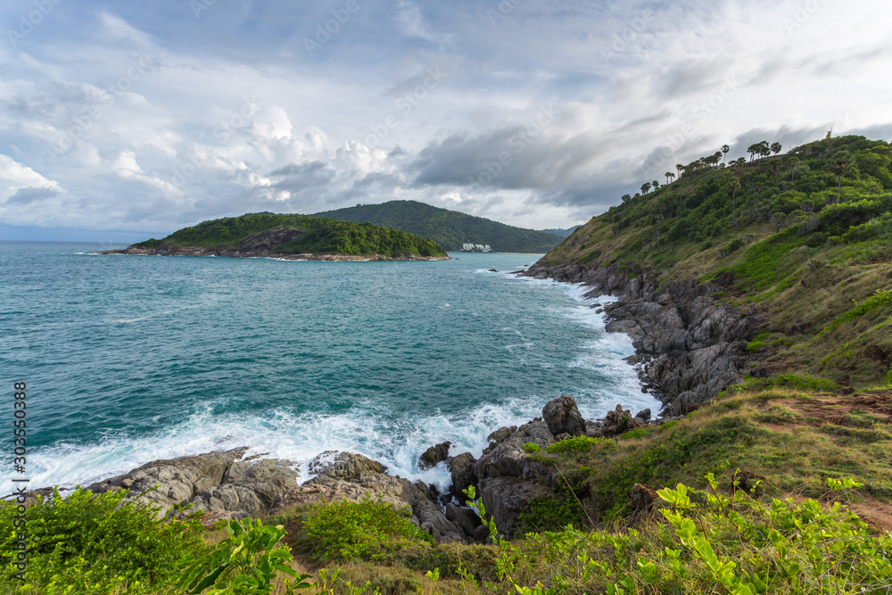Coast of the cape in the Andaman Sea, landscape in cloudy weather, rocks and bushes on the shore Coast of the cape in the Andaman Sea, landscape in cloudy weather, rocks and bushes on the shore