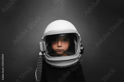 Small child wants to fly an airplane wearing an airplane helmet © vovan