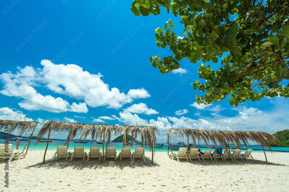 Sunbeds on a paradise island, a sunny day on the beach of the resort