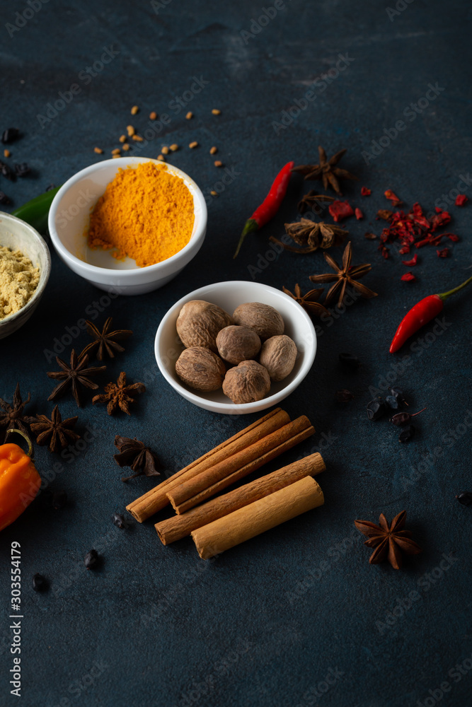 Cinnamon, nutmeg and other spice mix on blue background