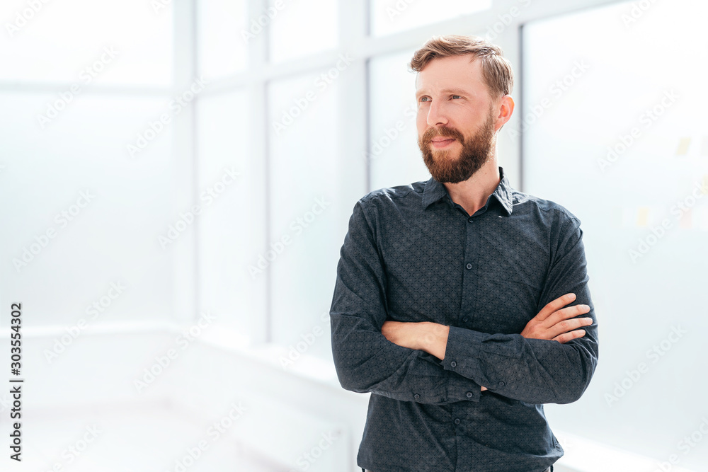 successful businessman standing near the office window successful businessman standing near the office window