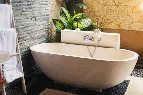 Big stone bathtub in a modern luxury villa photo