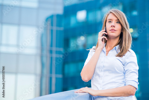 Beautiful Female Business Executive On Cell Phone In Modern City