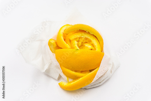 Organic freshness Orange fruit slice and peel taste sweet and sour in white tissue paper after ate on isolate white background 
