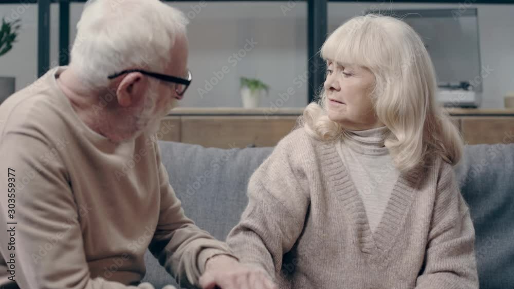 Senior man calming down upset wife with dementia Senior man calming down upset wife with dementia