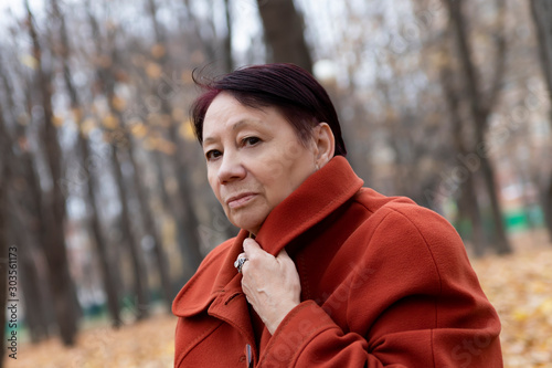 Senior woman in the park in autumn