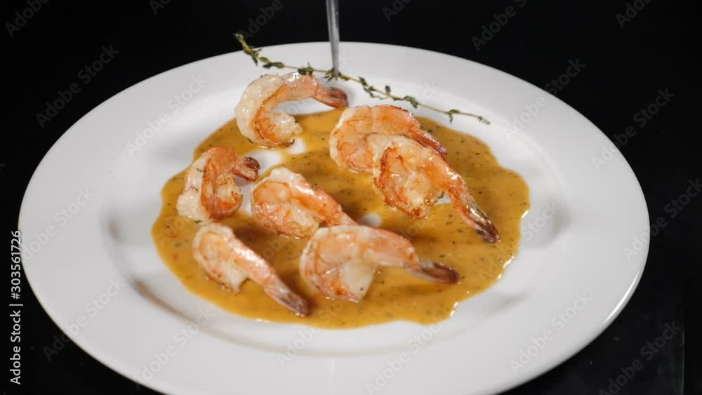 Chef decorating deep fried prawns in white plate cooked at restaurant kitchen. serving dish giving final touch. Slow motion. hd