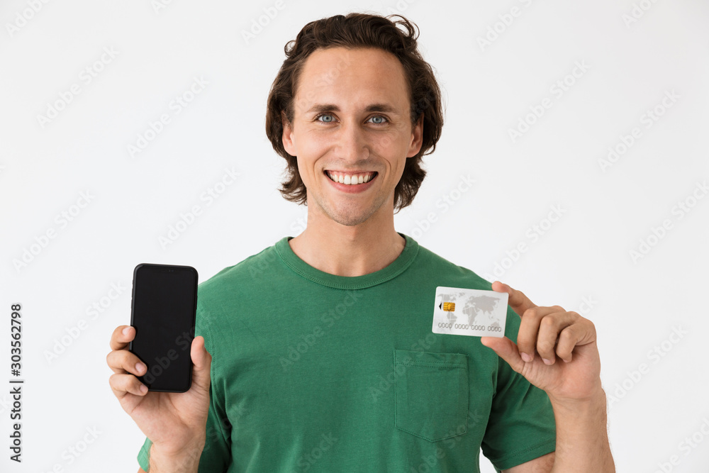 Φωτογραφία Image of masculine brunette man holding cash money and smartphone