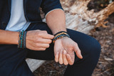 Hands of man with bracelets on both hands. Place for text or advertising