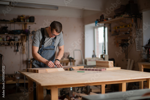 View of the carpentry shop in which a man works © Anton