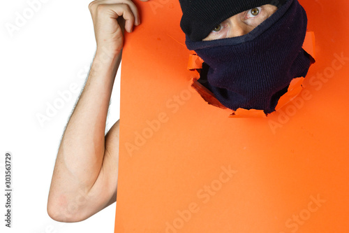 man with balaclava with his head coming out of a red cardboard on White background photo