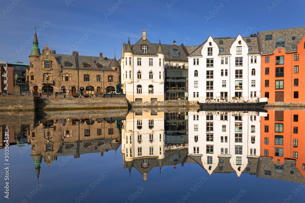 Colorful architecture of Alesund reflected in the water, Norway