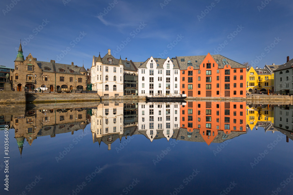 Colorful architecture of Alesund reflected in the water, Norway