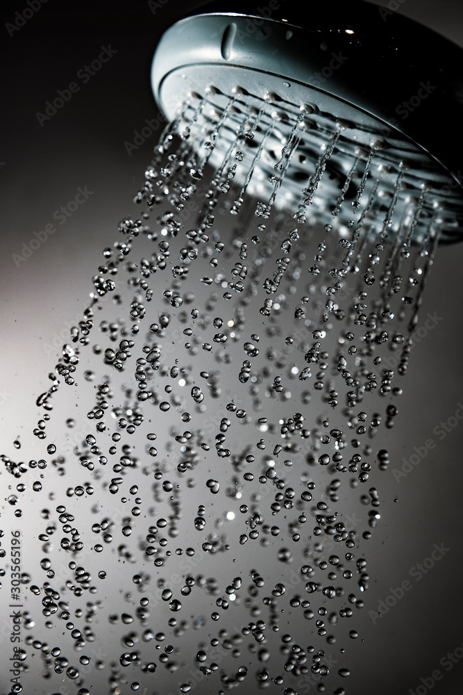 Shower head and water drops in frozen motion.