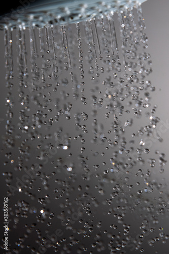 Shower head and water drops in frozen motion.