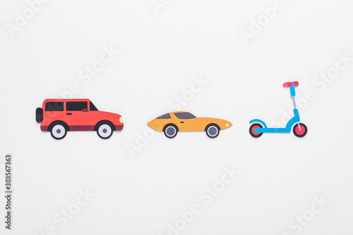 top view of paper cut vehicles on white background