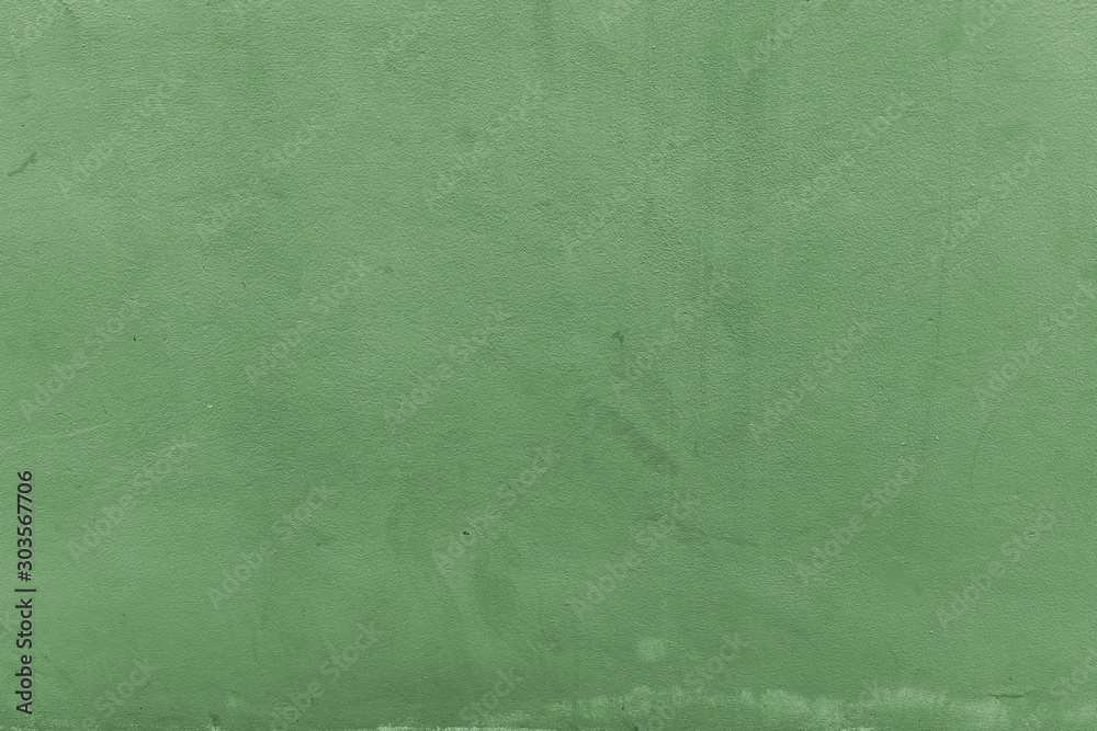 Old grunge cracked vintage green concrete and cement mold texture wall or floor background with weathered paint and scratches.