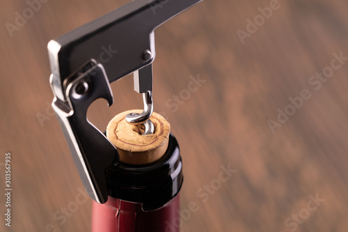 Corkscrew and bottle of wine
