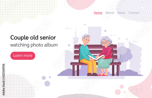 Couple old senior sitting on the bench watching photo album.