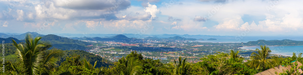 Panorama of Phuket from a height, green hills in the middle of the sea