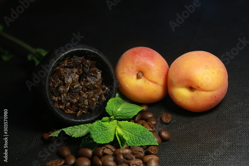 bowl with tobacco for hookah. passion fruit on a dark background. smoking hooka