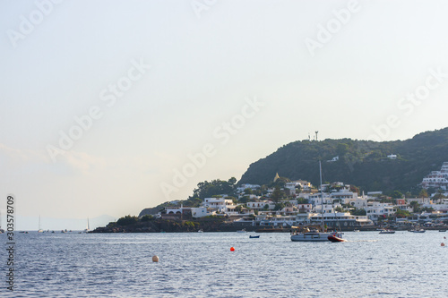 Italian Sicily Catania Filicudi Island seashore with buildings and yachts in water