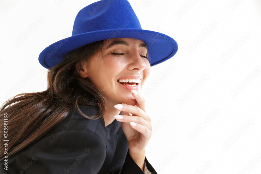 Optimistic happy woman in blue hat posing isolated