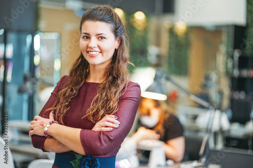 Fotografie Young charming smiling woman owner of beauty salon nail bar, concept of own smal