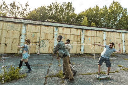 Zombies go for meat on a stick, zombies in harness and skateboarder