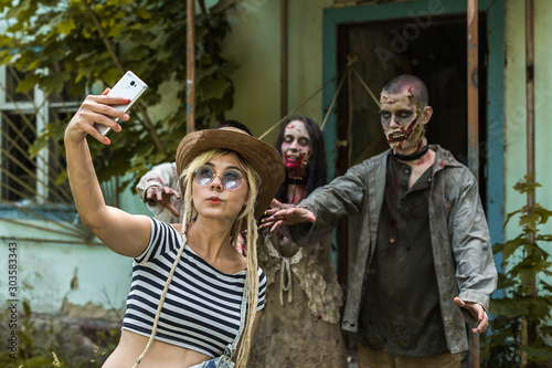 Selfie on a background of zombies, zombies tied to an abandoned house