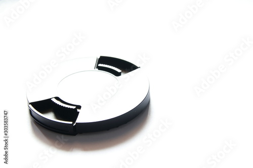 Black cover for the lens on a white background with a reflection of light.    The contours of the round object on a white background.