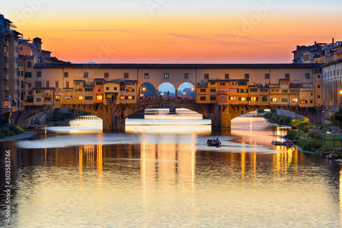 Sunset view of Ponte Vecchio over Arno River in Florence, Italy. Architecture and landmark of Florence. Cityscape of Florence