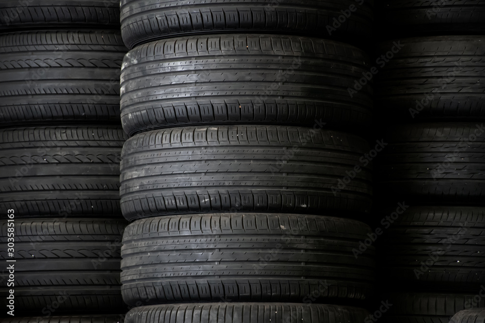 Old used car tires stacked in the repair garage. Old used car tires stacked in the repair garage.