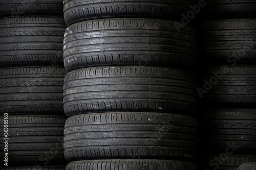 Old used car tires stacked in the repair garage.