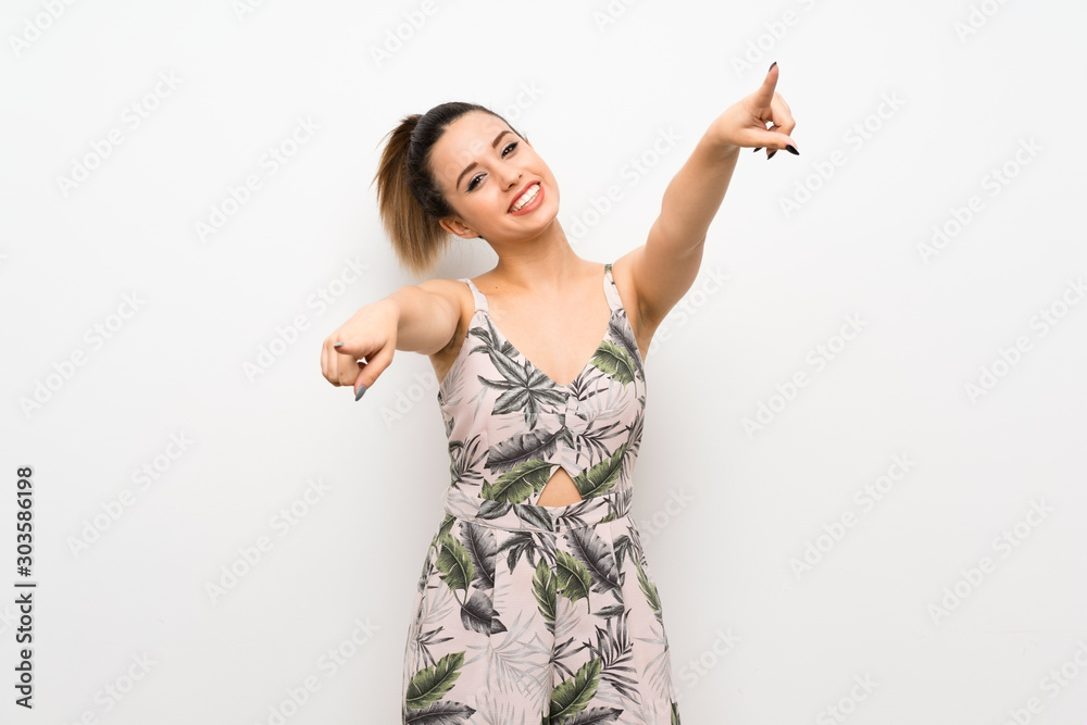 Young woman over isolated white background points finger at you while smiling Young woman over isolated white background points finger at you while smiling