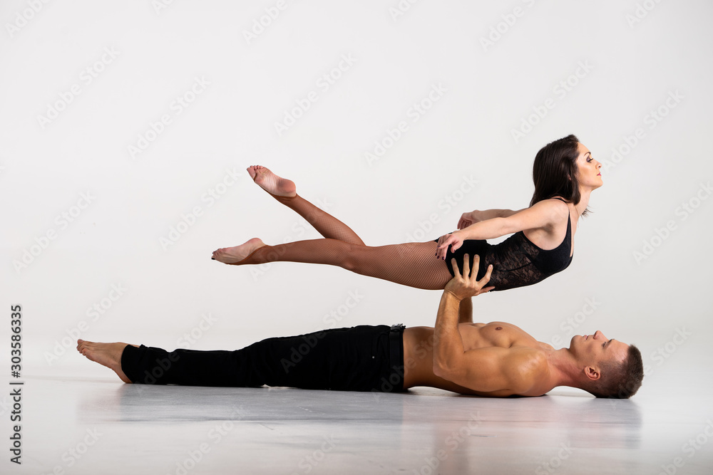 Duo Of Acrobats Showing hand to hand Trick, Isolated On White