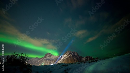 spectacular northern light aurora borealis distant mountain night scenery blue light in sky photo