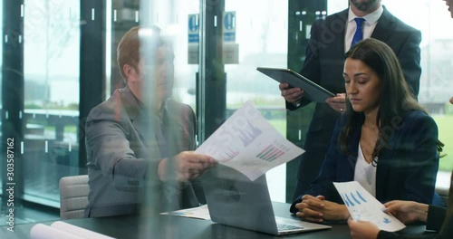 4K Businesswoman looking unhappy & depressed in a meeting with colleagues