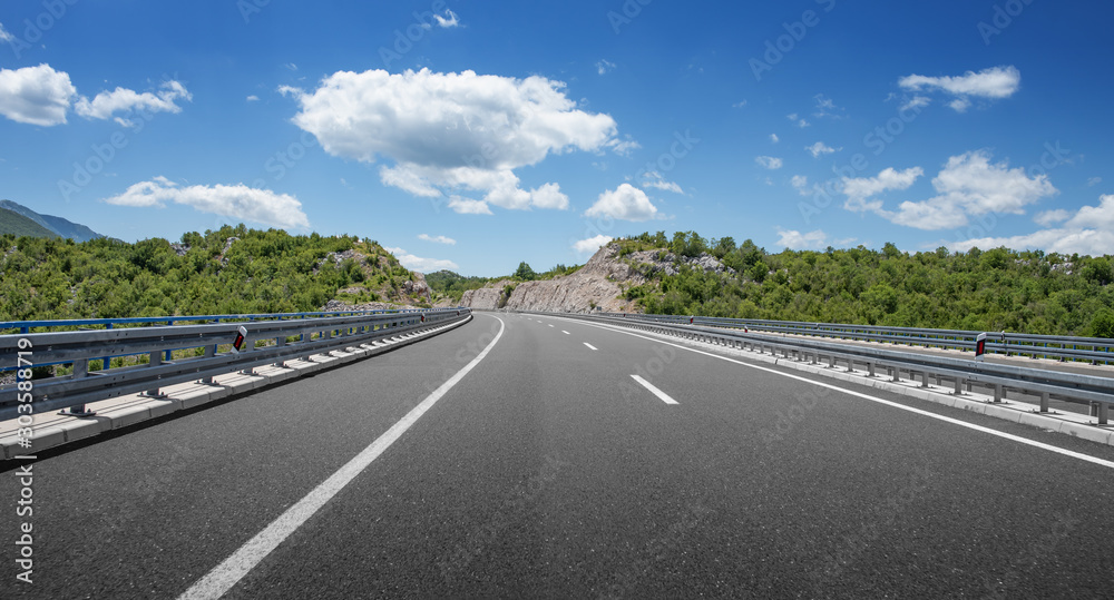 Mountain highway with blue sky and rocky mountains on a background. Mountain highway with blue sky and rocky mountains on a background.