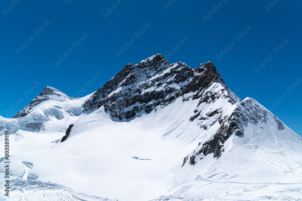 Panoramic view on winter snowy mountains at nice sunny evening.