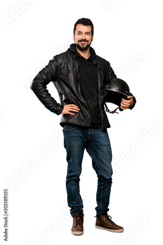 Full-length shot of Biker man posing with arms at hip and smiling over isolated white background