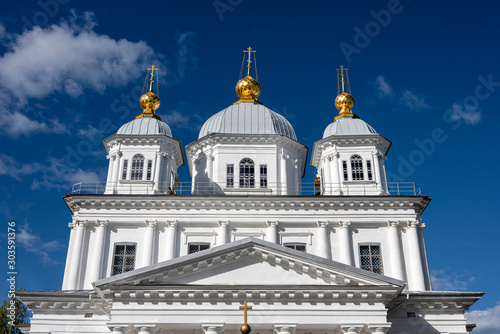Russia, Golden Ring, Yaroslavl, near Volga river: Front view of famous white onion domed Kasan Convent in the city center of the Russian town with blue sky in background - concept orthodox religion.
