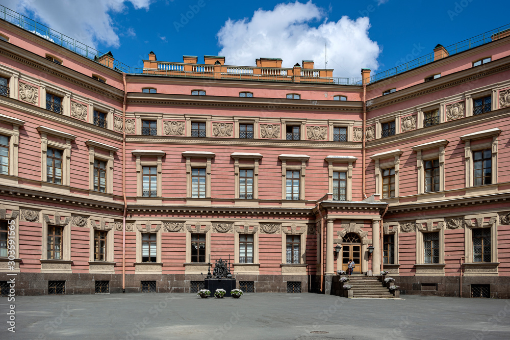 Russia, Saint Petersburg: Inner courtyard of famous Saint Michael's Castle facade in the city center of the Russian towns with bronze Monument to Emperor Paul I - history tsar sculpture.