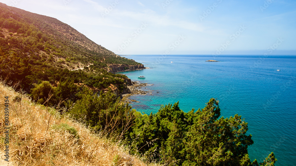 bay landscape, wild beach in the blue lagoon, mountains and ocean