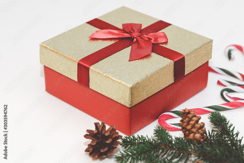 Christmas concept, new year concept. Gift Box, candy staff,candy canes Christmas tree branches. Fir tree branches,close up.Toned.White background. Christmas concept, new year concept. Gift Box, candy staff,candy canes Christmas tree branches. Fir tree branches,close up.Toned.White background.