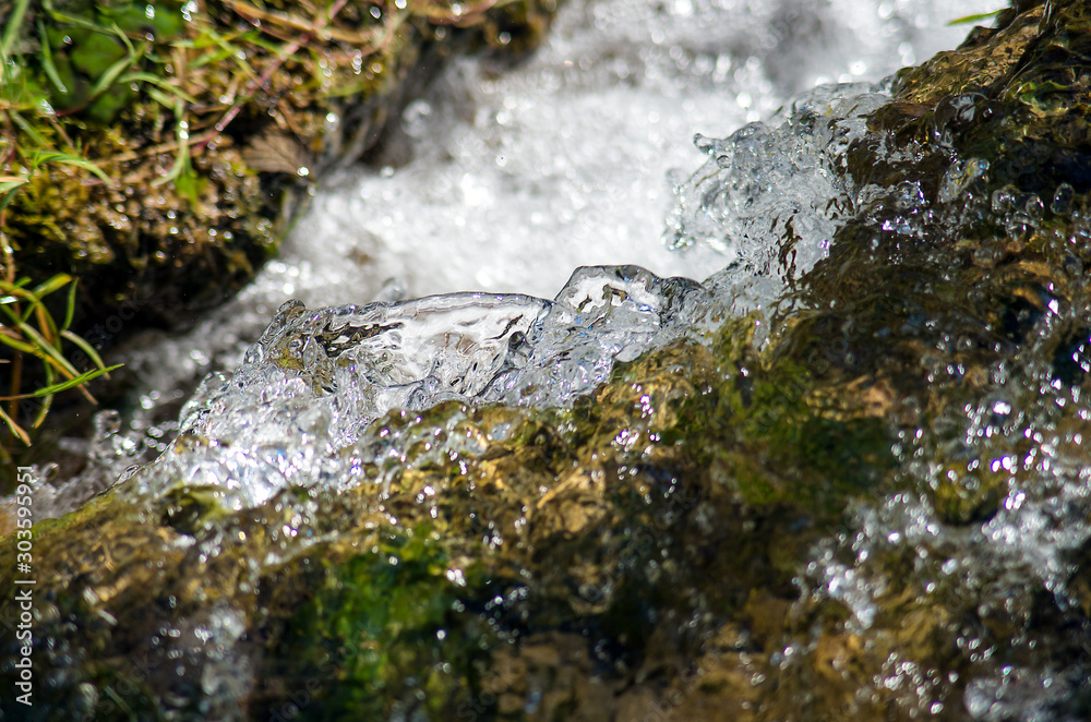 Fototapeta premium Fast-flowing water in a mountain river.