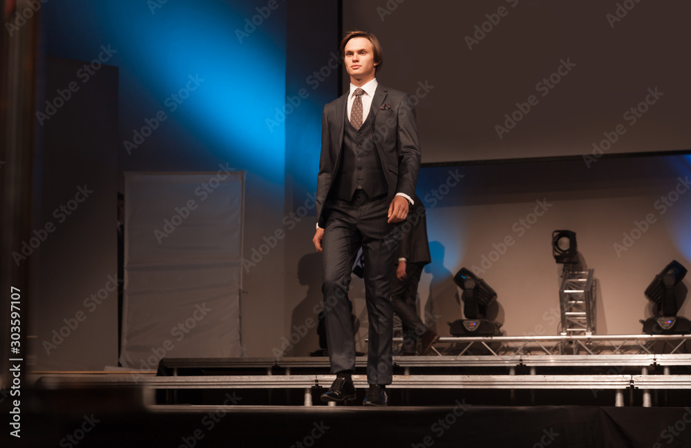 handsome male model posing on the podium