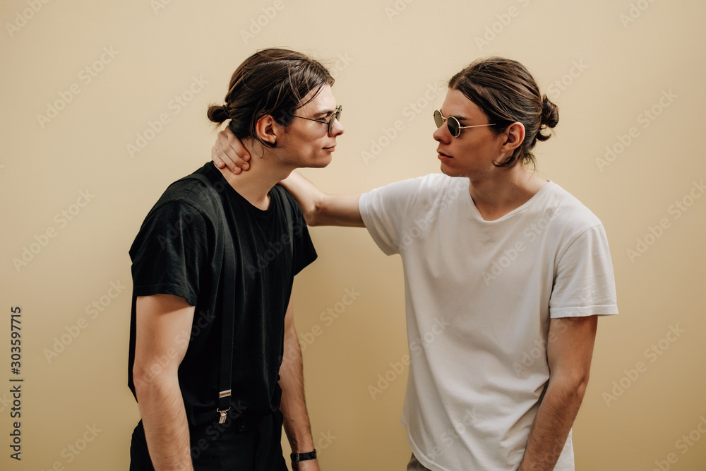 Close Up Portrait of Two Stylish Twins Brothers Dressed in Black and White T-shirts